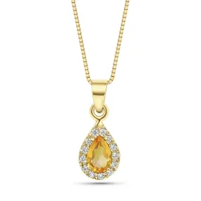 A drop-shaped halo pendant with a citrine stone on a 14K gold chain.